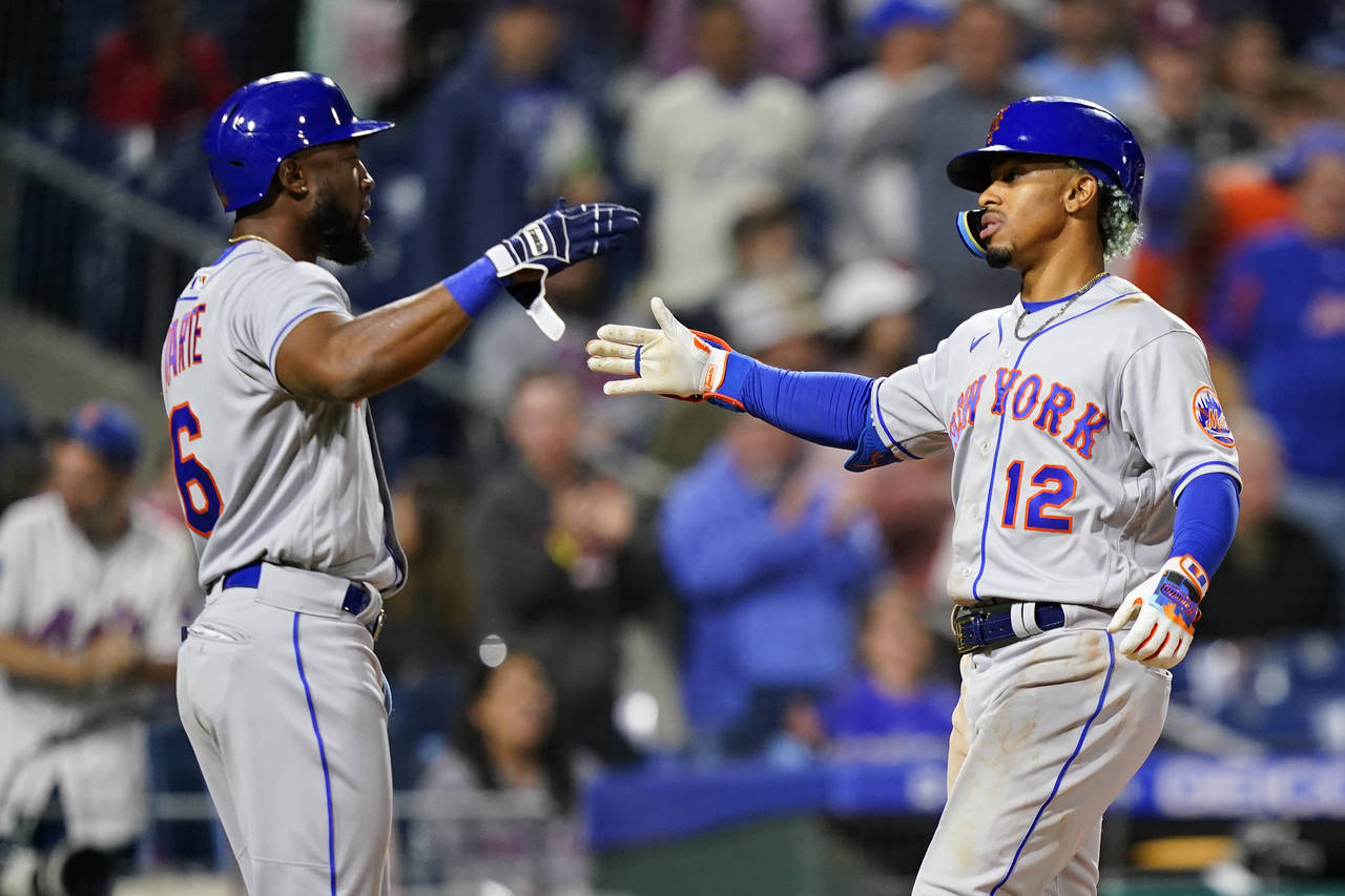 New York Mets' Starling Marte, left, and Francisco Lindor celebrate after Lindor's two-run home run...