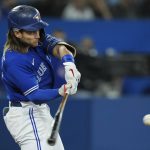 
              Toronto Blue Jays' Bo Bichette hits an RBI single against he New York Yankees during the fifth inning of a baseball game Tuesday, May 3, 2022, in Toronto. (Nathan Denette/The Canadian Press via AP)
            