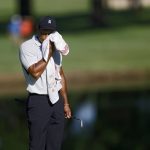 
              Tiger Woods wipes his face on the 11th green during a practice round for the PGA Championship golf tournament at Southern Hills Country Club on Monday, May 16, 2022, in Tulsa, Okla. (Mike Simons/Tulsa World via AP)
            
