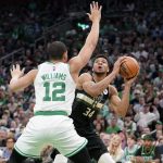 
              Boston Celtics forward Grant Williams (12) defends as Milwaukee Bucks forward Giannis Antetokounmpo (34) looks for an opening around him during the first half of Game 7 of an NBA basketball Eastern Conference semifinals playoff series, Sunday, May 15, 2022, in Boston. (AP Photo/Steven Senne)
            