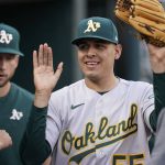 
              Oakland Athletics starting pitcher Adrian Martinez is greeted in the dugout after being relieved during the sixth inning of the second baseball game of a doubleheader against the Detroit Tigers, Tuesday, May 10, 2022, in Detroit. (AP Photo/Carlos Osorio)
            
