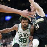
              Boston Celtics guard Marcus Smart (36) drives as Milwaukee Bucks guard Pat Connaughton (24) tries to defend during the second half of Game 7 of an NBA basketball Eastern Conference semifinals playoff series, Sunday, May 15, 2022, in Boston.  (AP Photo/Steven Senne)
            