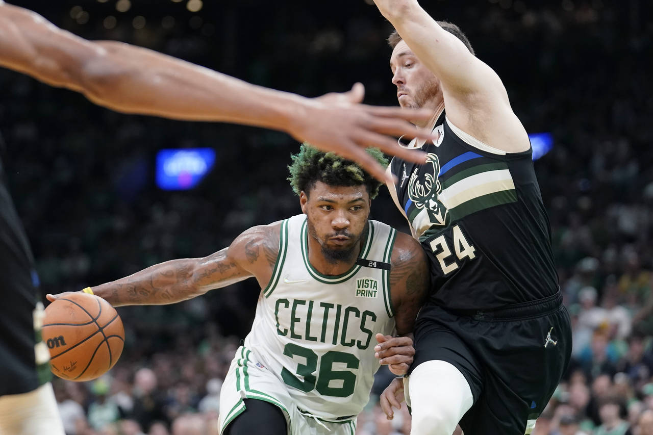 Boston Celtics guard Marcus Smart (36) drives as Milwaukee Bucks guard Pat Connaughton (24) tries t...
