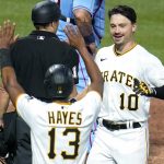 
              Pittsburgh Pirates' Bryan Reynolds (10) celebrates with Ke'Bryan Hayes (13) after they scored on Reynolds' inside-the-park home run off St. Louis Cardinals starting pitcher Matthew Liberatore during the fifth inning of a baseball game in Pittsburgh, Saturday, May 21, 2022. (AP Photo/Gene J. Puskar)
            