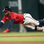 
              Atlanta Braves' Ozzie Albies slides into second base with a double in the sixth inning of a baseball game against the San Diego Padres, Friday, May 13, 2022, in Atlanta. (AP Photo/John Bazemore)
            