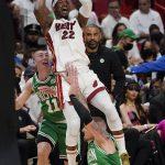 
              Miami Heat forward Jimmy Butler (22) attempts to score over Boston Celtics guard Payton Pritchard (11) and center Daniel Theis (27) during the first half of Game 1 of an NBA basketball Eastern Conference finals playoff series, Tuesday, May 17, 2022, in Miami. (AP Photo/Lynne Sladky)
            