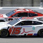 
              Harrison Burton (21) and J.J.Yeley (15) race side-by-side while coming out of Turn 4 during a NASCAR Cup Series auto race at Kansas Speedway in Kansas City, Kan., Sunday, May 15, 2022. (AP Photo/Colin E. Braley)
            