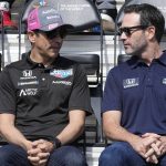 
              Helio Castroneves, left, of Brazil, talks with Jimmie Johnson during the drivers meeting for the Indianapolis 500 auto race at Indianapolis Motor Speedway, Saturday, May 28, 2022, in Indianapolis. (AP Photo/Darron Cummings)
            