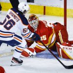 
              Edmonton Oilers right wing Kailer Yamamoto, left, scores on Calgary Flames goalie Jacob Markstrom during the third period of Game 1 of an NHL hockey second-round playoff series Wednesday, May 18, 2022, in Calgary, Alberta. (Jeff McIntosh/The Canadian Press via AP)
            
