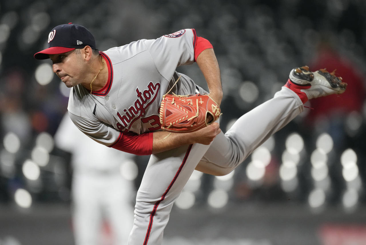 Washington Nationals relief pitcher Paolo Espino works against the Colorado Rockies during the nint...