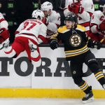 
              Boston Bruins' Connor Clifton (75) checks Carolina Hurricanes' Andrei Svechnikov (37) during the second period in Game 6 of an NHL hockey Stanley Cup first-round playoff series Thursday, May 12, 2022, in Boston. (AP Photo/Michael Dwyer)
            