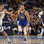 
              Golden State Warriors guard Stephen Curry (30) brings the ball upcourt ahead of Memphis Grizzlies forward Brandon Clarke (15) in the second half during Game 1 of a second-round NBA basketball playoff series Sunday, May 1, 2022, in Memphis, Tenn. (AP Photo/Brandon Dill)
            