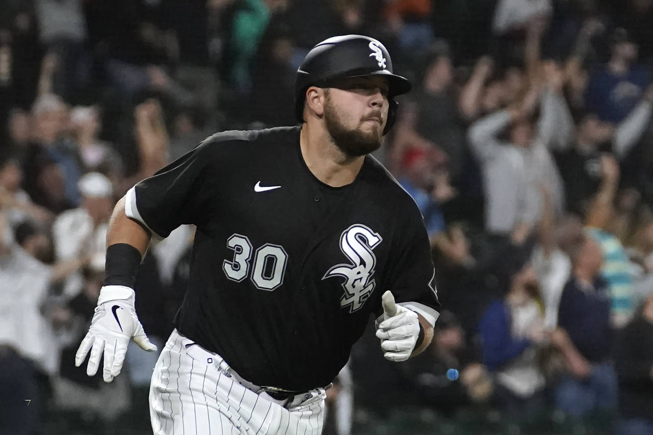 Chicago White Sox's Jake Burger runs the bases after hitting a three-run home run off Boston Red So...