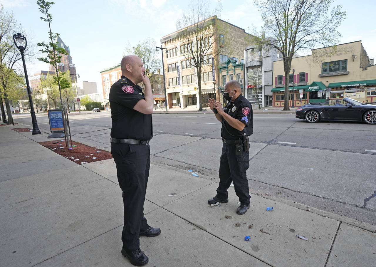MSOE Public Safety officers investigate the scene of a shooting near the corner of North Water Stre...