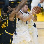 
              Dallas Mavericks guard Luka Doncic, right, is defended by Golden State Warriors forward Andrew Wiggins during the first half of Game 1 of the NBA basketball playoffs Western Conference finals in San Francisco, Wednesday, May 18, 2022. (AP Photo/Jeff Chiu)
            