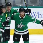 
              FILE - Dallas Stars forward Joe Pavelski, right, is congratulated by forwards Jason Robertson (21) and Roope Hintz (24) after scoring a goal during the first period of an NHL hockey game against the Seattle Kraken, Wednesday, April 12, 2022, in Dallas. Jason Robertson is a 40-goal scorer with almost as many assists in his second NHL season, and doesn't even have the most points on the top line for the Dallas Stars. Neither does fellow young 20-something forward Roope Hintz. Joe Pavelski is a point-a-game player at 37 years old, the grizzled veteran that is part of the the most-productive trio for the Stars since the team’s first season in Big D nearly three decades ago. (AP Photo/Brandon Wade, File)
            