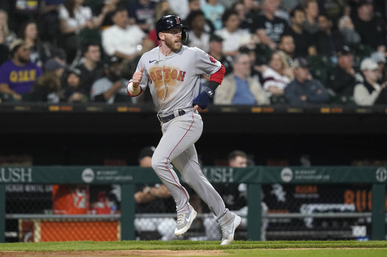 Boston Red Sox's Trevor Story looks back at Alex Verdugo as he scores on Verdugo's double during th...