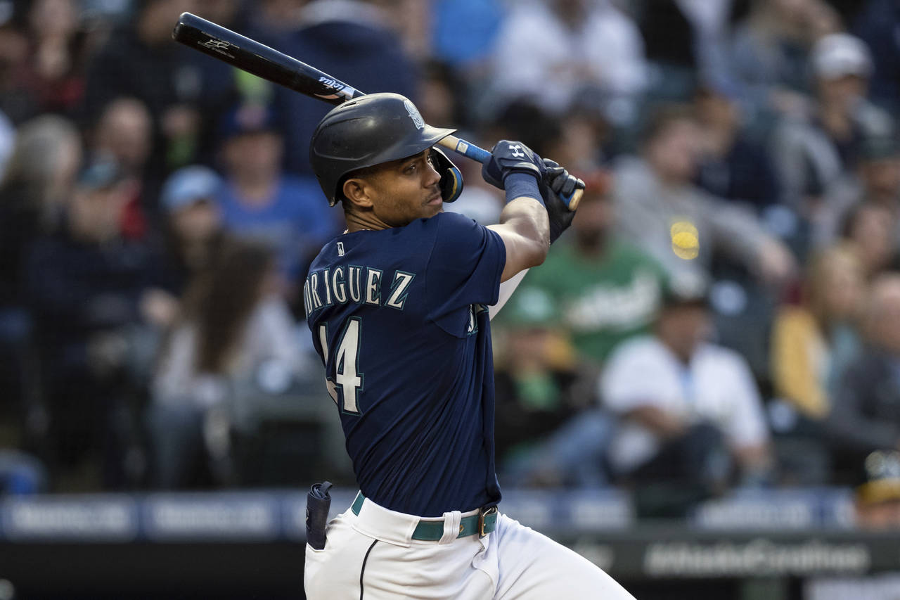 Seattle Mariners' Julio Rodriguez hits a single off Oakland Athletics starting pitcher Zach Logue d...