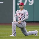 
              Los Angeles Angels' Shohei Ohtani stretches in the outfield before the team's baseball game against the Boston Red Sox at Fenway Park, Tuesday, May 3, 2022, in Boston. (AP Photo/Mary Schwalm)
            