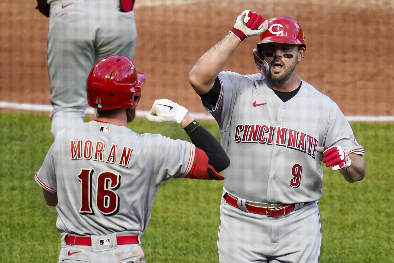 Cincinnati Reds' Mike Moustakas (9) celebrates with Colin Moran (16) after hitting a solo home run ...