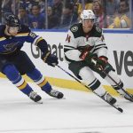 
              Minnesota Wild's Joel Eriksson Ek (14) works the puck against St. Louis Blues' Colton Parayko (55) during the first period in Game 4 of an NHL hockey Stanley Cup first-round playoff series on Sunday, May 8, 2022, in St. Louis. (AP Photo/Michael Thomas)
            
