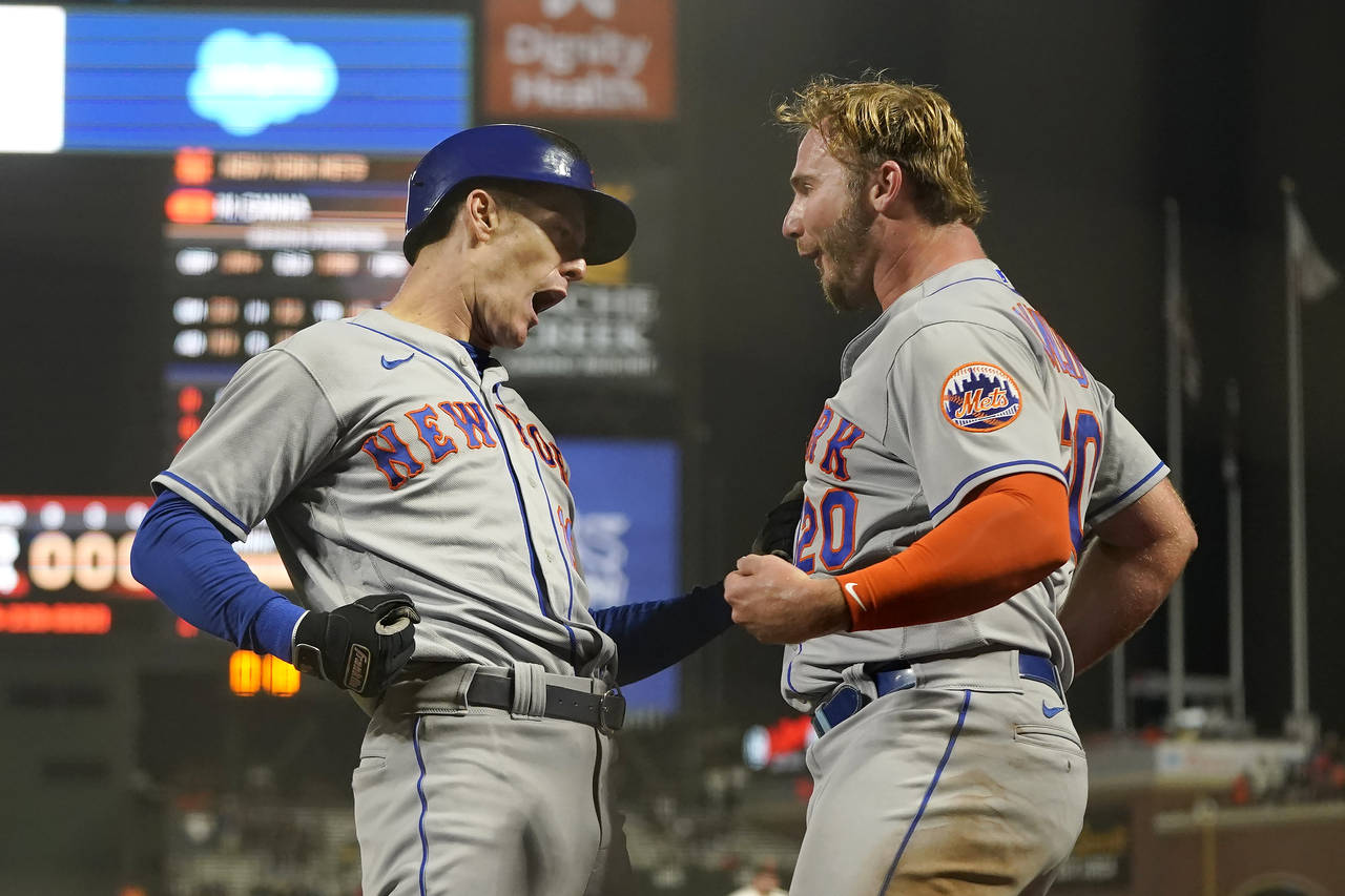 New York Mets' Mark Canha, left, is congratulated by Pete Alonso after hitting a home run against t...