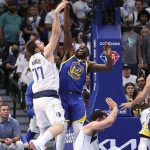 
              Golden State Warriors' Draymond Green reaches for a rebound in front of Dallas Mavericks' Luka Doncic during the first quarter in Game 4 of NBA basketball playoffs Western Conference finals in Dallas on Tuesday, May 24, 2022. (Scott Strazzante/San Francisco Chronicle via AP)
            