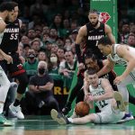 
              Boston Celtics' Payton Pritchard (11) and Grant Williams, right, vie for possession of the ball against Miami Heat's Gabe Vincent during the first half of Game 3 of the NBA basketball playoffs Eastern Conference finals Saturday, May 21, 2022, in Boston. (AP Photo/Michael Dwyer)
            