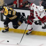 
              Boston Bruins' Curtis Lazar (20) and Carolina Hurricanes' Jordan Staal (11) battle for the puck during the second period of Game 3 of an NHL hockey Stanley Cup first-round playoff series, Friday, May 6, 2022, in Boston. (AP Photo/Michael Dwyer)
            