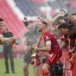 
              Liverpool players celebrate at the end of the English FA Cup final soccer match between Chelsea and Liverpool, at Wembley stadium, in London, Saturday, May 14, 2022. (AP Photo/Kirsty Wigglesworth)
            