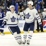 
              Toronto Maple Leafs right wing Ilya Mikheyev (65) celebrates with left wing Pierre Engvall (47) after his second goal against the Tampa Bay Lightning during the third period in Game 3 of an NHL hockey first-round playoff series Friday, May 6, 2022, in Tampa, Fla. (AP Photo/Chris O'Meara)
            