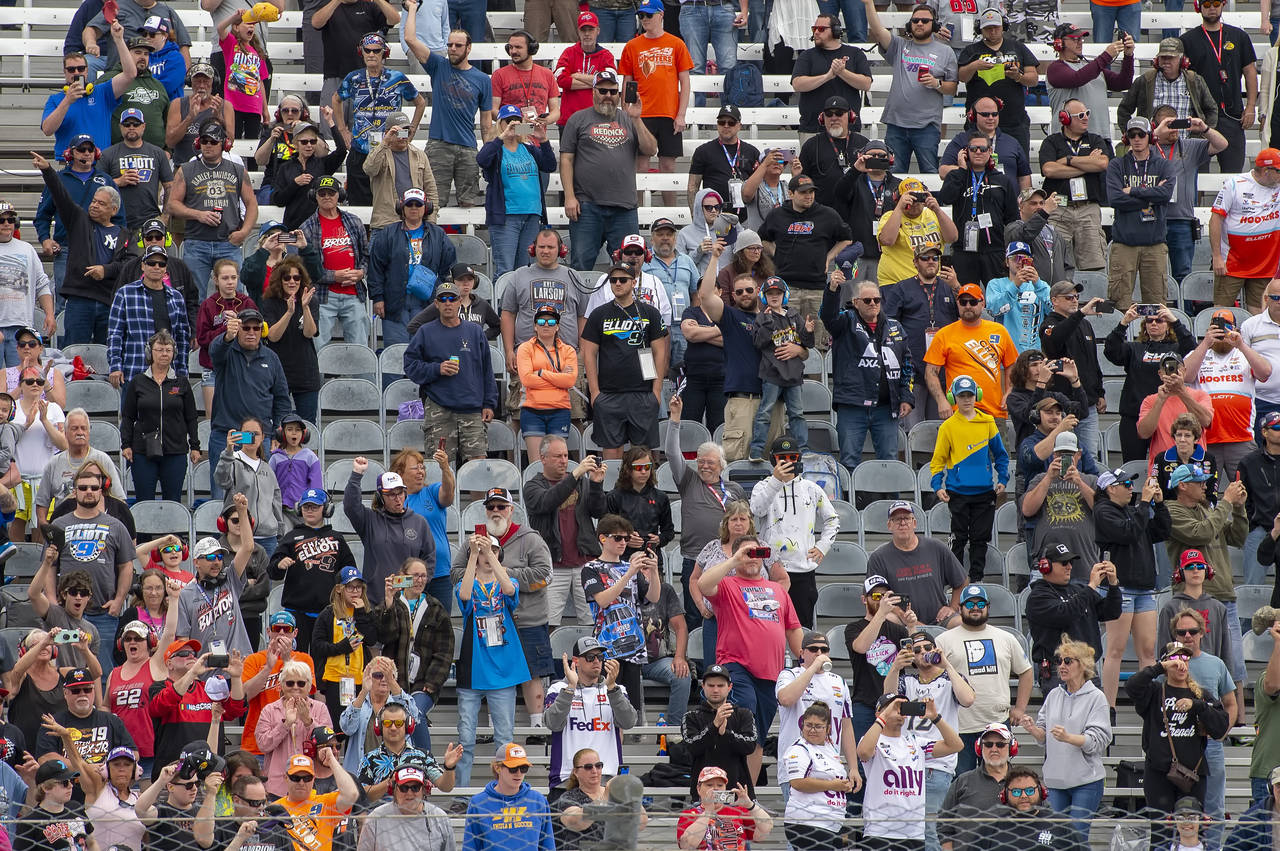 Fans watch from the stands at the NASCAR Cup Series auto race at Dover Motor Speedway, Monday, May ...