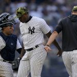 
              New York Yankees relief pitcher Aroldis Chapman (54) is relieved by manager Aaron Boone, right, in the ninth inning of a baseball game against the Chicago White Sox, Sunday, May 22, 2022, in New York. (AP Photo/John Minchillo)
            