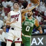
              Miami Heat guard Tyler Herro (14) drives to the basket as Boston Celtics forward Jayson Tatum (0) defends during the first half of Game 2 of the NBA basketball Eastern Conference finals playoff series, Thursday, May 19, 2022, in Miami. (AP Photo/Lynne Sladky)
            