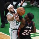 
              Boston Celtics guard Derrick White (9) passes the ball while pressured by Miami Heat forward Jimmy Butler (22) during the first half of Game 4 of the NBA basketball playoffs Eastern Conference finals, Monday, May 23, 2022, in Boston. (AP Photo/Charles Krupa)
            