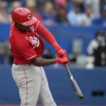 
              Cincinnati Reds' Aristides Aquino (44) connects for a two-run double against the Toronto Blue Jays during first-inning baseball game action in Toronto, Sunday, May 22, 2022. (Frank Gunn/The Canadian Press via AP)
            