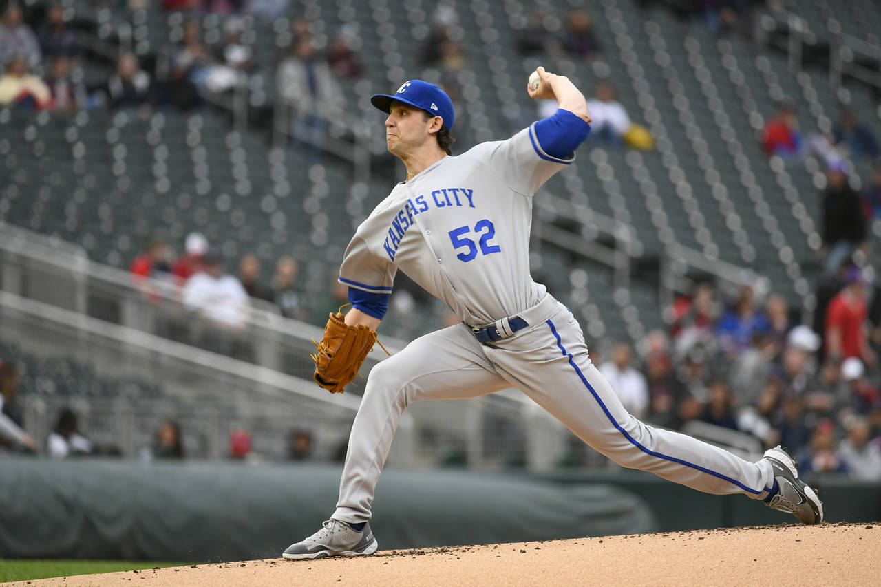 Kansas City Royals pitcher Daniel Lynch throws to a Minnesota Twins batter during the first inning ...