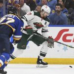 
              Minnesota Wild's Marcus Foligno (17) works with the puck as St. Louis Blues' Niko Mikkola (77) defends during the first period in Game 3 of an NHL hockey Stanley Cup first-round playoff series Friday, May 6, 2022, in St. Louis. (AP Photo/Michael Thomas)
            