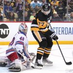 
              New York Rangers goaltender Alexandar Georgiev (40) blocks a shot and Pittsburgh Penguins' Jeff Carter (77) cannot get his stick on the rebound during the second period in Game 3 of an NHL hockey Stanley Cup first-round playoff series in Pittsburgh, Saturday, May 7, 2022. (AP Photo/Gene J. Puskar)
            