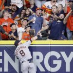 
              Detroit Tigers right fielder Robbie Grossman leaps but can only watch as a fan catches a home run by Houston Astros' Martin Maldonado during the second inning of a baseball game Friday, May 6, 2022, in Houston. (Kevin M. Cox/The Galveston County Daily News via AP)
            