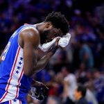 
              Philadelphia 76ers' Joel Embiid wipes his face during the first half of Game 6 of an NBA basketball second-round playoff series against the Miami Heat, Thursday, May 12, 2022, in Philadelphia. (AP Photo/Matt Slocum)
            