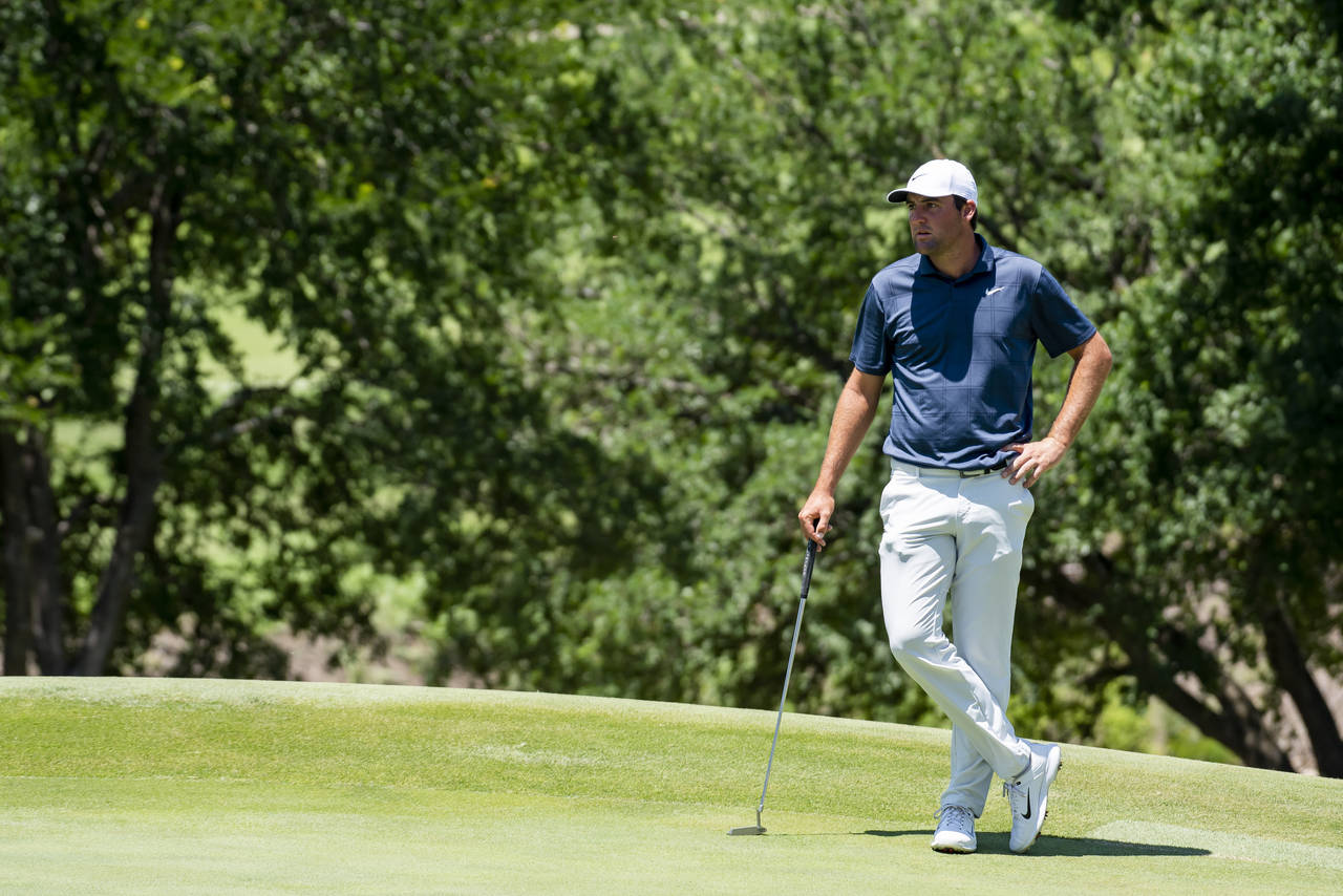 Scottie Scheffler waits to putt on the first hole during the first round of the AT&T Byron Nelson g...
