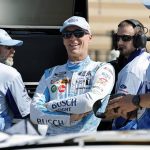 
              Kevin Harvick, center, visits his crew along pit road before practice for a NASCAR Cup Series auto race at Kansas Speedway in Kansas City, Kan., Saturday, May 14, 2022. (AP Photo/Colin E. Braley)
            