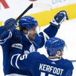 
              Toronto Maple Leafs forward Auston Matthews (34) celebrates his goal with teammate Alexander Kerfoot (15) during the third period of Game 1 of an NHL hockey Stanley Cup first-round playoff series against the Tampa Bay Lightning in Toronto, Monday, May 2, 2022. (Frank Gunn/The Canadian Press via AP)
            