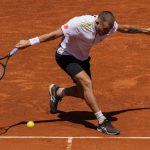 
              Daniel Evans of Britain returns the ball during a match against Andrey Rublev of Russia at the Mutua Madrid Open tennis tournament in Madrid, Thursday, May 5, 2022. (AP Photo/Bernat Armangue)
            