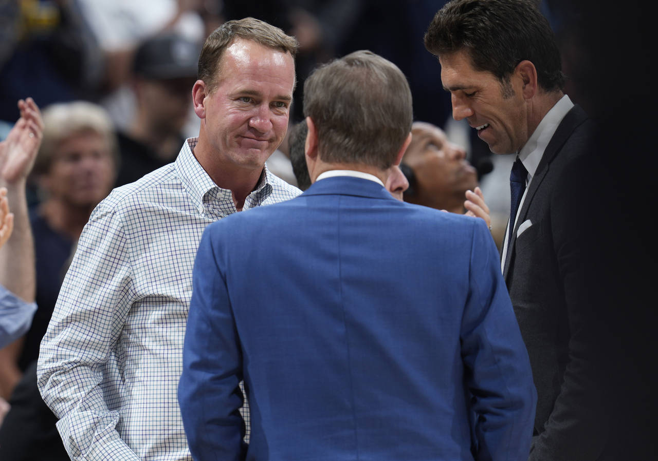 Former NFL quarterback Peyton Manning, left, chats with Joe Lacob, majority owner of the Golden Sta...