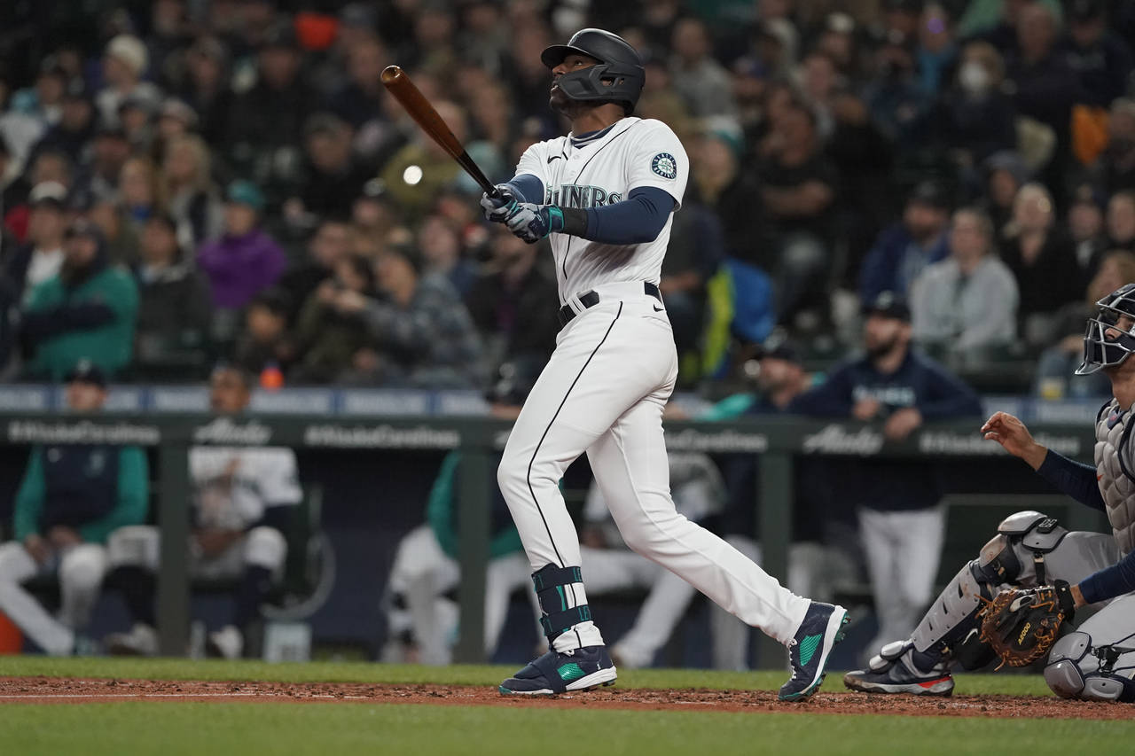 Seattle Mariners' Kyle Lewis watches his a solo home run against the Houston Astros during the seco...