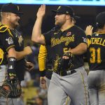 
              Pittsburgh Pirates relief pitcher David Bednar, center, celebrates with his teammates after defeating the Los Angeles Dodgers 6-5 in a baseball game Monday, May 30, 2022, in Los Angeles. (AP Photo/John McCoy)
            