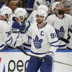 
              Toronto Maple Leafs center John Tavares (91) celebrates his goal against the Tampa Bay Lightning with the bench during the second period in Game 6 of an NHL hockey first-round playoff series Thursday, May 12, 2022, in Tampa, Fla. (AP Photo/Chris O'Meara)
            