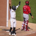 
              Pittsburgh Pirates' Rodolfo Castro, left, celebrates as teammate Ke'Bryan Hayes (not shown) beats out a fielder's choice, allowing Castro to score from third, during the eighth inning of a baseball game against the Cincinnati Reds in Pittsburgh, Sunday, May 15, 2022. (AP Photo/Gene J. Puskar)
            